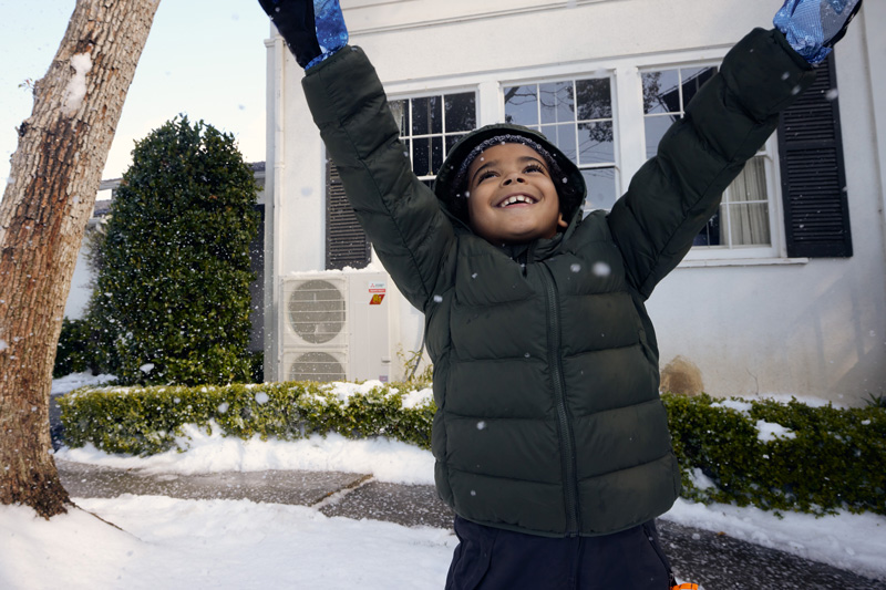 Happy Kid Playing Outside In Snow.